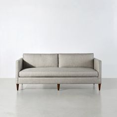 a couch sitting on top of a white floor