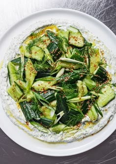 a white plate topped with cucumber and herbs