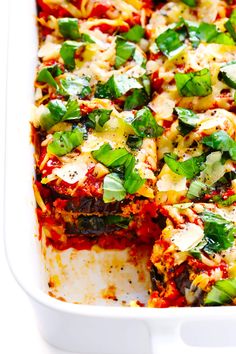 a casserole dish filled with meat, cheese and veggie toppings