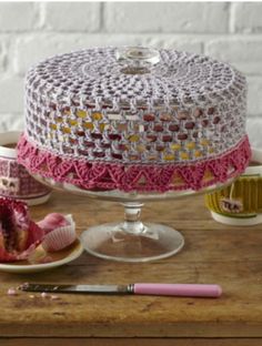 a crocheted cake sitting on top of a wooden table