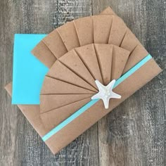 a brown card with a starfish on it sitting on top of a wooden table