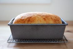 a loaf of bread sitting on top of a metal pan