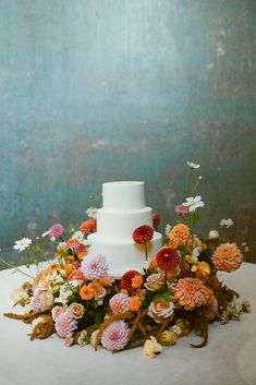 a white wedding cake with flowers on top