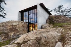 a house sitting on top of a rocky hillside