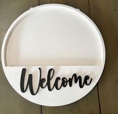 a sign that says welcome hanging on a wall