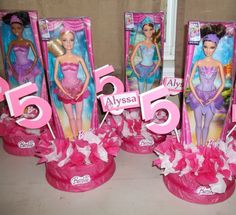 three barbie dolls in pink and purple packaging with the numbers 5, 6, 7, 9