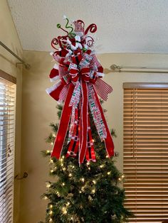 a christmas tree decorated with ribbons and lights