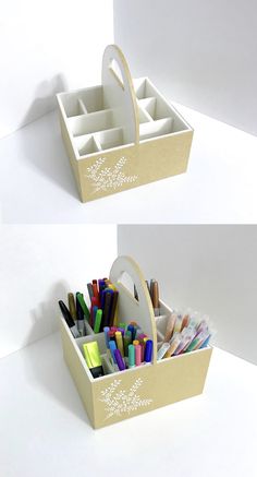 two boxes with pens, pencils and markers in them sitting on a white surface