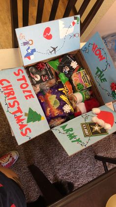 an open box filled with christmas treats on the floor