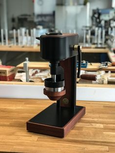 a coffee maker sitting on top of a wooden table