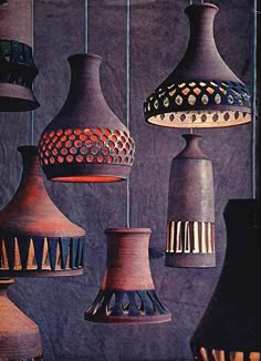 a group of different colored lamps hanging from the ceiling