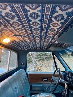 the interior of an old car is decorated with blue and white designs on it's ceiling