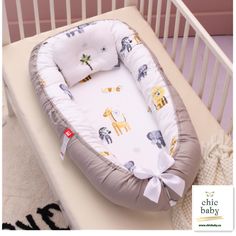 a baby crib with a blanket on top of it next to a stuffed animal