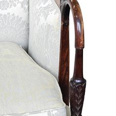 a close up of a wooden headboard and foot board on a white bed frame