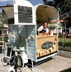 a man standing in front of a food cart