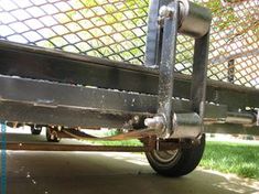 the back end of a metal bench with wheels and spokes on it's sides