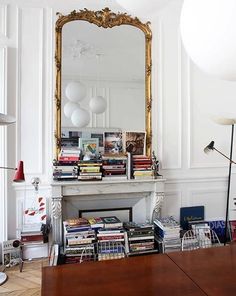 a living room filled with furniture and a large mirror