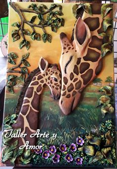 a cake decorated to look like two giraffes hugging each other in the grass