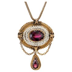 Antique, early 1800's garnet and pearl domed pendant necklace. Oval garnet center stone with a 3 row halo of pearls, set in 14k yellow gold with a pear shaped garnet dangle. 18 inch 14k yellow gold chain. One genuine reddish Garnet, approx. total weight 3.50cts, VS, 12 x 9 oval One genuine pear Garnet, approx. total weight 1.30cts Approx. 50 natural drilled pearls 1.5mm 14k Yellow Gold 13.3 grams Top to bottom: 44.45mm or 1.75 inches Width: 31.31mm or 1.23 inches Depth: 12.80mm Length: 18 inches 1.4mm handmade wheat style chain 1800s Jewelry, Garnet And Pearl, Lalique Jewelry, Ruby Necklace Pendant, Sabyasachi Jewellery, Antique Pendant, Natural Pearl, Yellow Gold Chain, Fantasy Jewelry