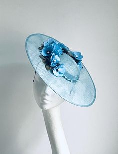 Pale blue flower Hat Pale blue Flower Hat will be an amazing accessory to compliment your outfit. The colours can easily pick the colours you would be wearing. A light blue saucer disc hat will fit an average head size. It's made from fabric covered metal headband attached to a pale blue colour sinamay saucer disc which sits pale blue flowers to match the hat.  To secure your fascinator there is a comb inside the hat attached to the headband, so the fascinator sits very steadily on your head. En Pale Blue Wedding, Kentucky Derby Fascinator, Blue Fascinator, Royal Ascot Hats, Derby Fascinator, Metal Headband, Flower Hat, Wedding Hat, Fascinator Hat