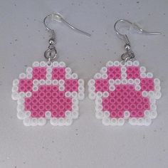 the earrings are made out of legos and have pink beads on them with silver earwires