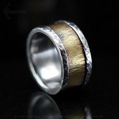 a wedding band with two gold and silver inlays on top of each other