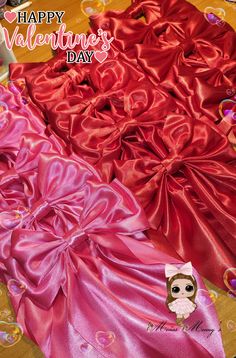 valentine's day greeting card with pink and red satin gowns on a table