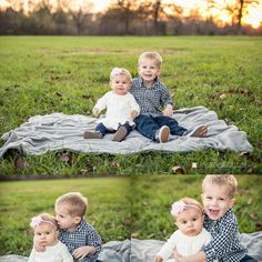 two toddlers are sitting on a blanket in the grass and one is holding an infant