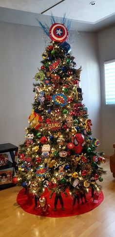 a decorated christmas tree in the corner of a room with an iron man decoration on it