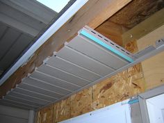 the inside of a house that is being built with wood and metal framing on the ceiling