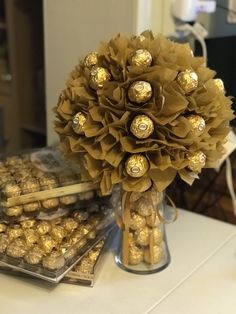 a vase filled with lots of chocolates on top of a table