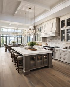 a large kitchen with an island in the middle and lots of counter space on one side