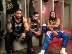 the men are sitting down in the locker room with their faces painted like clowns