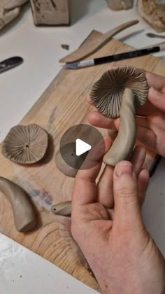 someone is carving mushrooms on a wooden board