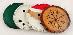 three pieces of wood with different designs on them, one has a santa hat and the other is a snowman