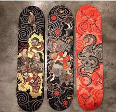 three skateboards sitting next to each other on a cement floor