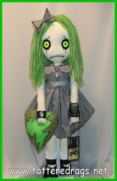 a creepy doll with green hair holding a heart