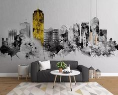 a living room with a couch, coffee table and large city skyline mural on the wall