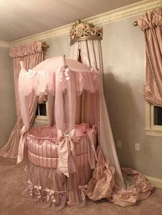 a pink canopy bed in the corner of a room