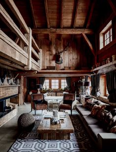 a living room filled with furniture and wooden walls