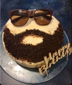 a cake with sunglasses on top of it and the words happy birthday written in frosting