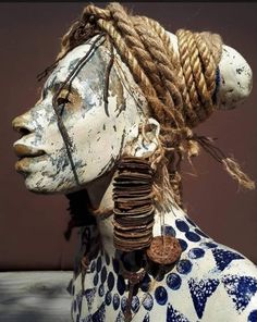 a white and blue statue with braids on it's head