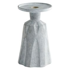 a toilet paper roll holder in the shape of a vase