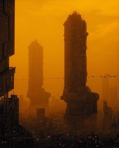 an orange sky with some buildings in the foreground and birds flying over them on a hazy day