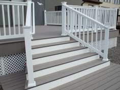 a close up of a set of stairs with white railings