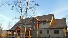 a large house sitting in the middle of a forest