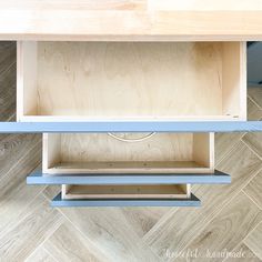 a wooden shelf with two shelves on each side, and one shelf below the shelf