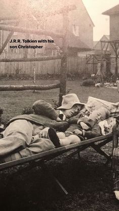 an old black and white photo of a man laying on a bed in the yard