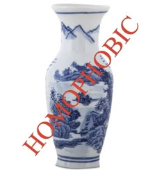 a blue and white vase sitting on top of a table