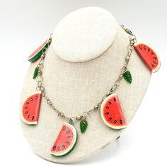 a necklace with watermelon slices hanging from it's sides on a mannequin